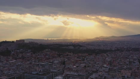 Aerial---General-shot-of-Athens,-Greece-under-a-cloudy-sunset