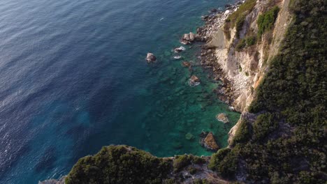 AERIAL-SIde-Panning-Shot-of-a-Cliffside-with-Beautiful-Mediterranean-Sea,-Albania