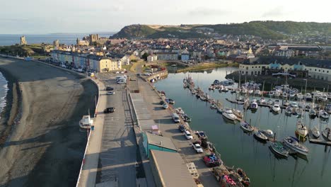 Drone-footage-on-a-summer-day-in-UK-Wales-Aberystwyth-around-the-beach,-harbour,-sea-side,-clif-and-town-front-2