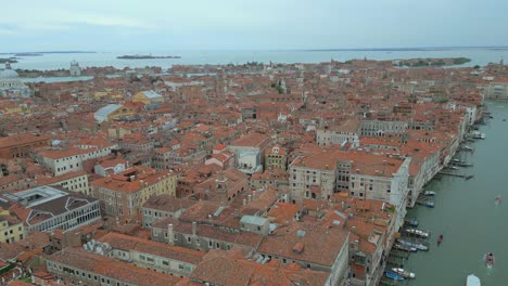 4K-Aerial-of-San-Marco,-the-Rialto-Bridge,-and-the-canals-in-Venice,-Italy-on-a-cloudy-day-5