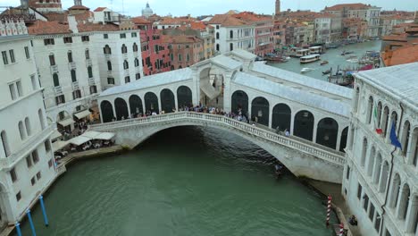 4K-Aerial-of-San-Marco,-the-Rialto-Bridge,-and-the-canals-in-Venice,-Italy-on-a-cloudy-day-3