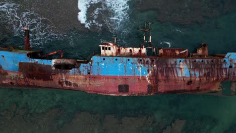 Sunken-Rusty-Ship-Lying-on-Side-Among-Crashing-Waves