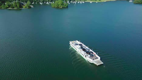 Elevated-Rotating-Aerial-Drone-View-Of-500-Year-Old-Car-Ferry-On-Lake-Windermere-From-Bowness-Nab-To-Far-Sawrey-On-Sunny-Summer-Morning-Showing-Algae-In-The-Lake-And-Ripples-On-The-Water
