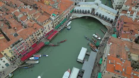 4K-Aerial-of-San-Marco,-the-Rialto-Bridge,-and-the-canals-in-Venice,-Italy-on-a-cloudy-day-6