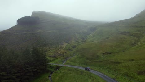 Driving-a-car-in-an-epic-scenery-in-a-fog-day-in-the-middle-of-the-mountains-in-Ireland