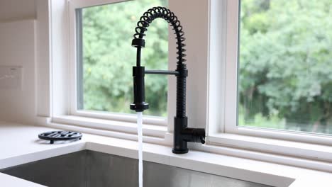 Pan-Right-of-Water-Running-In-Sink