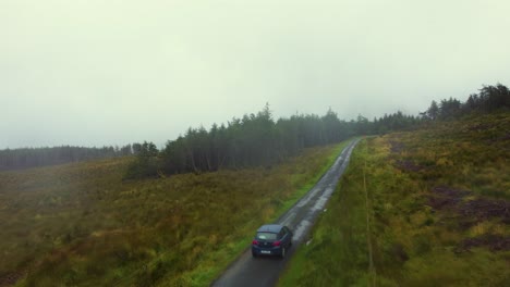 Driving-a-car-in-a-mountain-road-in-a-rainy-day