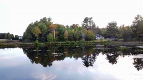 A-low-fly-over-shot-of-a-pond-in-Maine