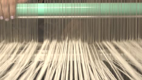 A-loom-with-threads-in-action-9