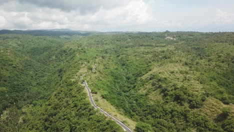Lone-road-on-picturesque-mountain-ridge-leads-to-Tanjung-Juntil,-Bali