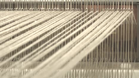 A-loom-with-threads-in-action-10