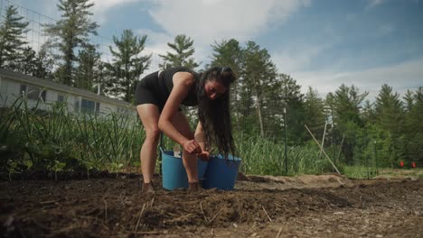 Gimbal-shot-of-woman-working-on-farm-in-garden