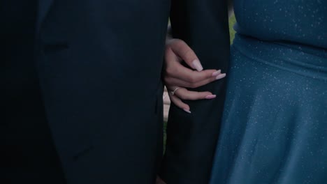 Close-up-tilt-shot-of-a-bride-and-groom-while-the-bride-takes-the-groom's-hand-during-a-wedding