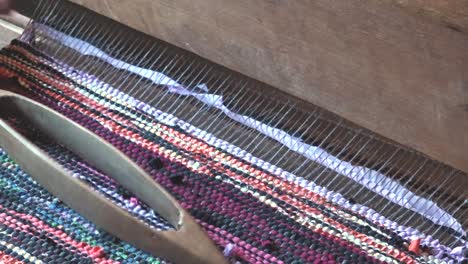 A-loom-with-threads-in-action-3