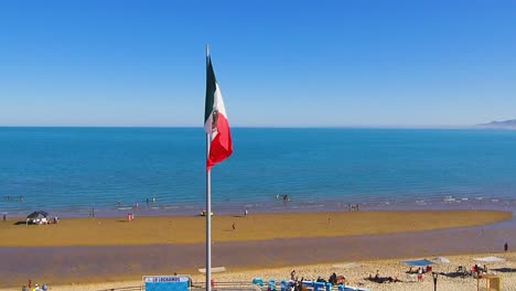 View-of-a-drone-flying-forward-over-a-pier-showing-the-Mexican-flag