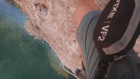 POV-action-cam-young-climber-in-Via-Ferrata-rock-wall-over-a-river-in-Cuenca,-Spain