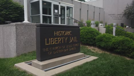The-camera-pass-by-of-the-sign-at-Liberty-Jail-a-Mormon-Visitor-Center-in-Liberty-Missouri