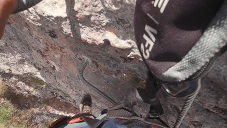 POV-action-cam-young-climber-in-Via-Ferrata-rock-wall-vertical-ascent