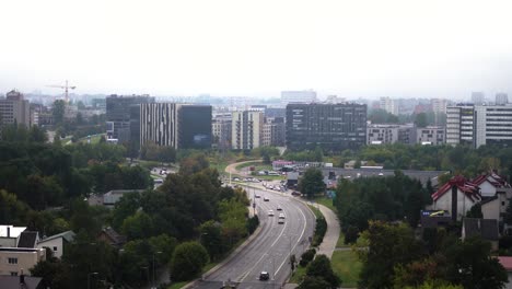 Establishing-shot-of-a-city-covered-in-fog-with-high-rises-and-road-leading-to-a-city