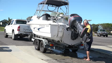 Man-attaching-boat-to-trailer