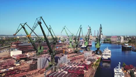 Drone-flying-forward-to-cranes-in-the-shipyard