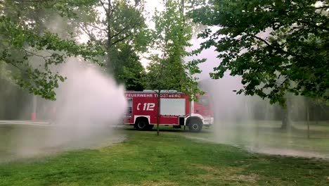 German-firetruck-spraying-water-for-kids-and-trees-on-a-hot-summer-day-4