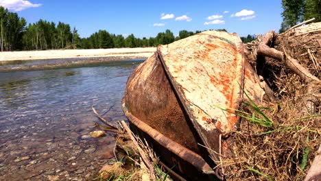 A-rusty-old-drift-boat-laying-on-the-river-bank-of-the-bitterroot-river