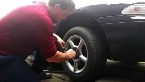 Man-changing-wheel-for-a-car.-Time-lapse