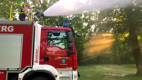 German-firetruck-spraying-water-for-kids-and-trees-on-a-hot-summer-day-12