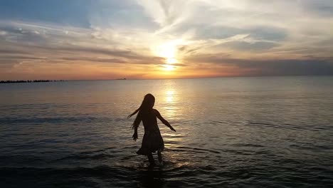 Silhouette-of-Young-Lady-Dancing-on-the-Beach-at-Sunset-1