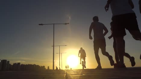 People-doing-exercise-with-a-sunset-in-the-background