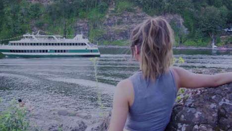 Cute-hipster-girl-watching-a-cruise-ship-go-by-from-the-edge-of-the-water