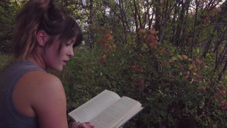 Cute-hipster-girl-relaxing-in-a-park-and-reading-a-book