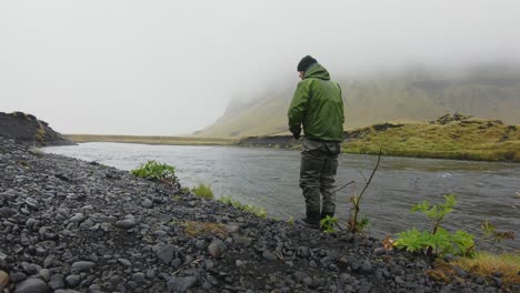 Flyfisher-casting-in-the-rain,-Iceland