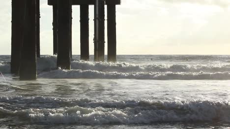 Wellen,-Die-Bei-Sonnenaufgang-In-Zeitlupe-Auf-Einen-Pier-Krachen