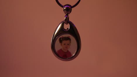 Close-Up-of-the-Hanging-Child's-Photo-in-Metal-Souvenir-Keychain-1