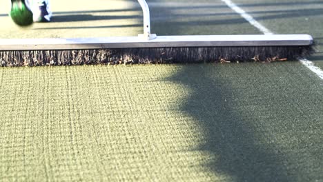 Soft-Clay-Tennis-Court-being-swept-for-maintenance