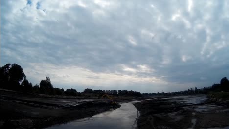 Excavator-Works-with-Bucket-to-Clear-Mud-Sludge-and-Debris-from-the-Bottom-of-the-Drained-River-1