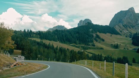 Drivers-point-of-view-of-a-beautiful-green,-mountainous-landscape