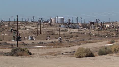 Oil-field-with-oil-tanls-and-oil-sin-California,-USA