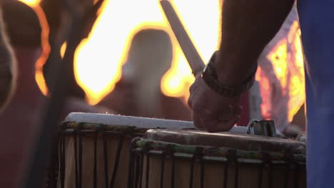 Slow-Motion-close-up-of-stick-hitting-drum-in-sunset-light-at-the-drum-circle-at-Siesta-Key-Beach