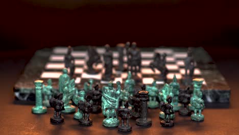 Ancient-marble-chessboard-with-teal-bronce-knights-as-pawns-slider-macro-2
