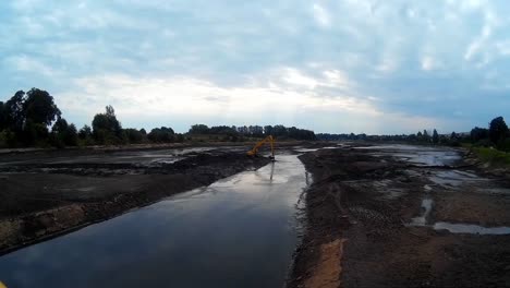 Excavator-Works-with-Bucket-to-Clear-Mud-Sludge-and-Debris-from-the-Bottom-of-the-Drained-River