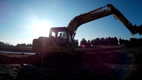 Yellow-Excavator-Moves-Through-the-Mud-and-Sludge-with-a-help-of-Bucket