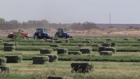 Production-of-hay-bales-on-field-in-California,-USA