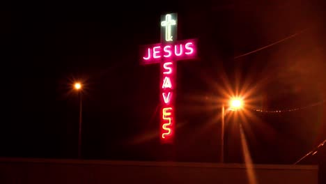 A-handheld-night-shot-of-a-neon-sign-which-reads-Jesus-Saves