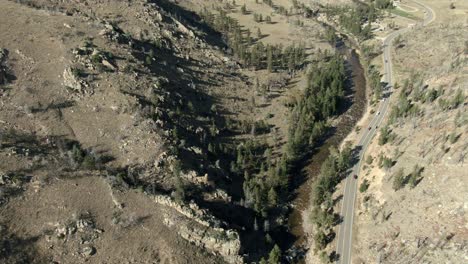 Aerial-pan-over-road-in-canyon-with-cars-in-Colorado