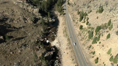 Aerial-dolly-over-road-in-canyon-with-cars-next-to-river-in-Colorado-1