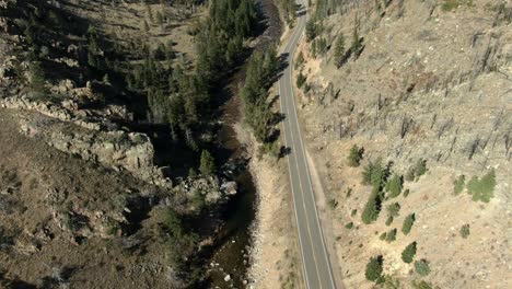 Aerial-of-empty-road-in-canyon-next-to-river-in-Colorado
