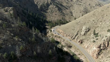 Aerial-dolly-over-road-in-canyon-with-cars-next-to-river-in-Colorado